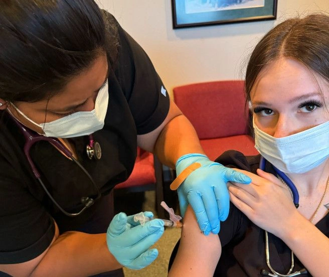 {{ school.name }} students training to administor blood draws