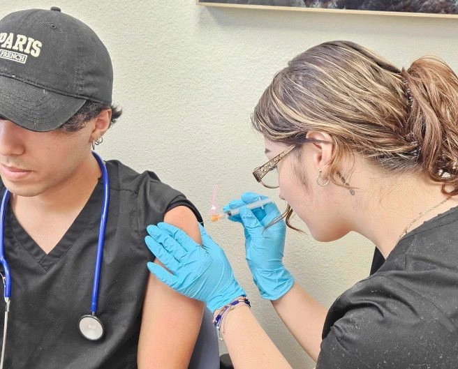 {{ school.name }} students training to administer injection